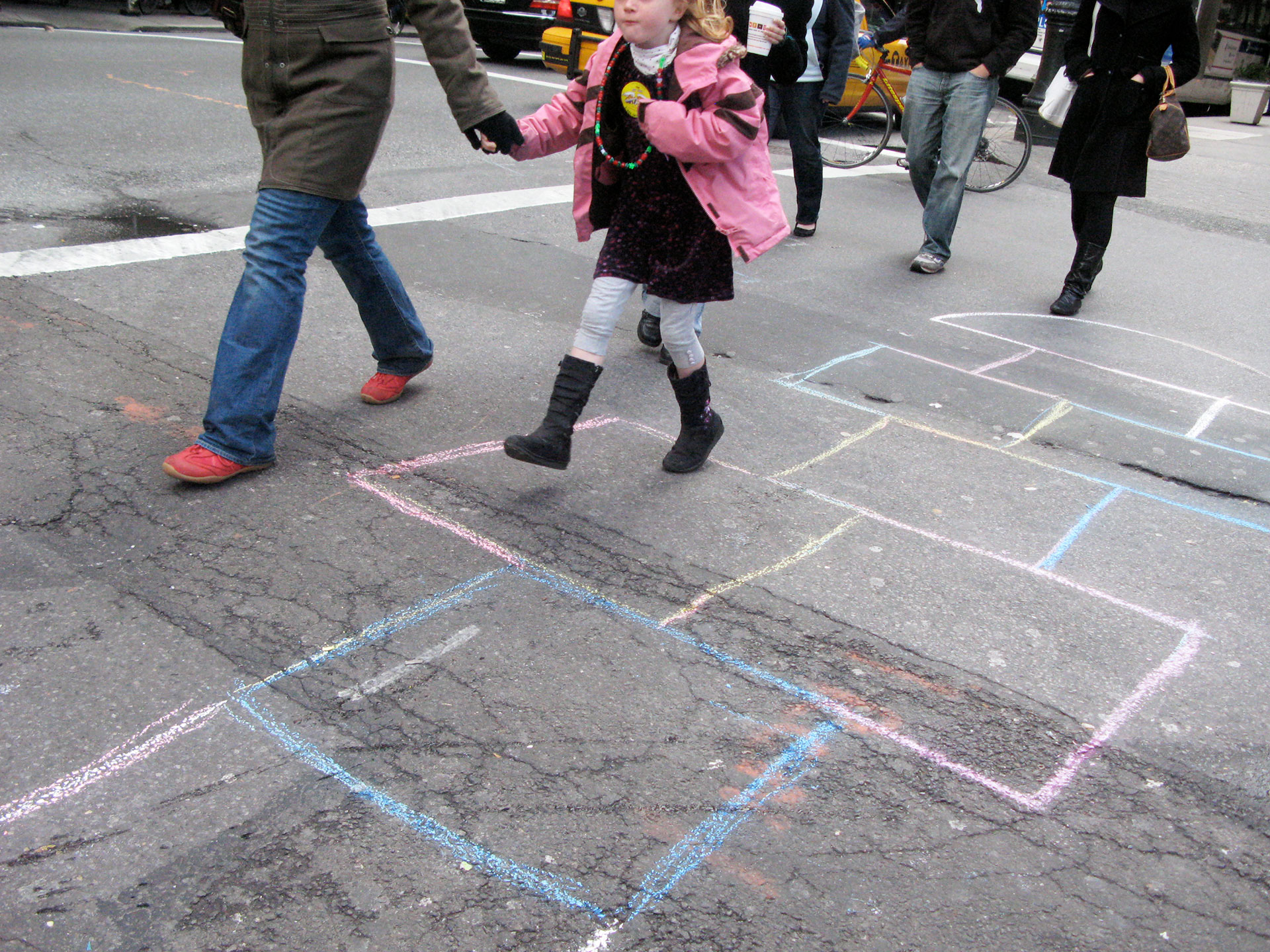 Girl hopping across the street